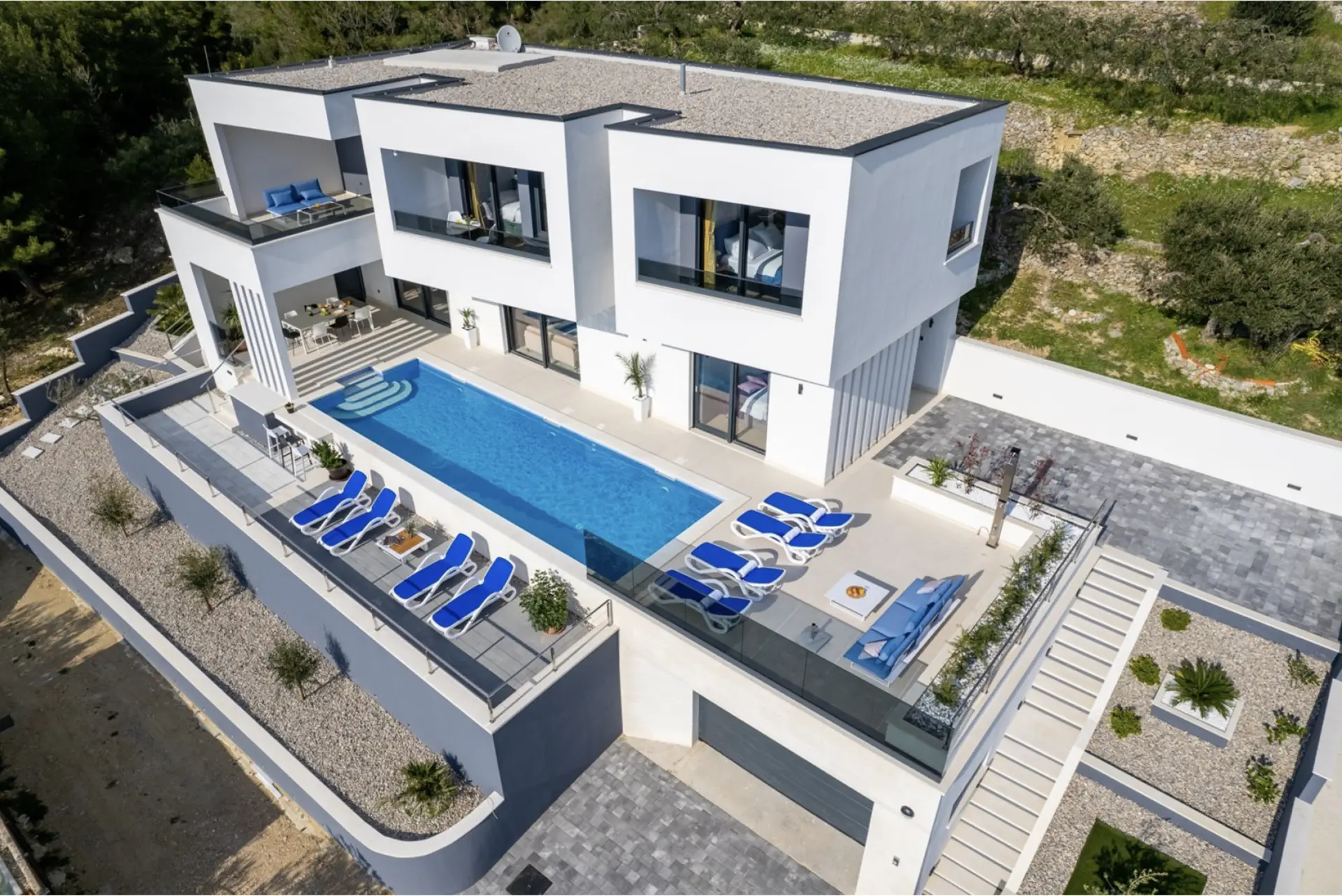 aerial view of a villa with pool loungers