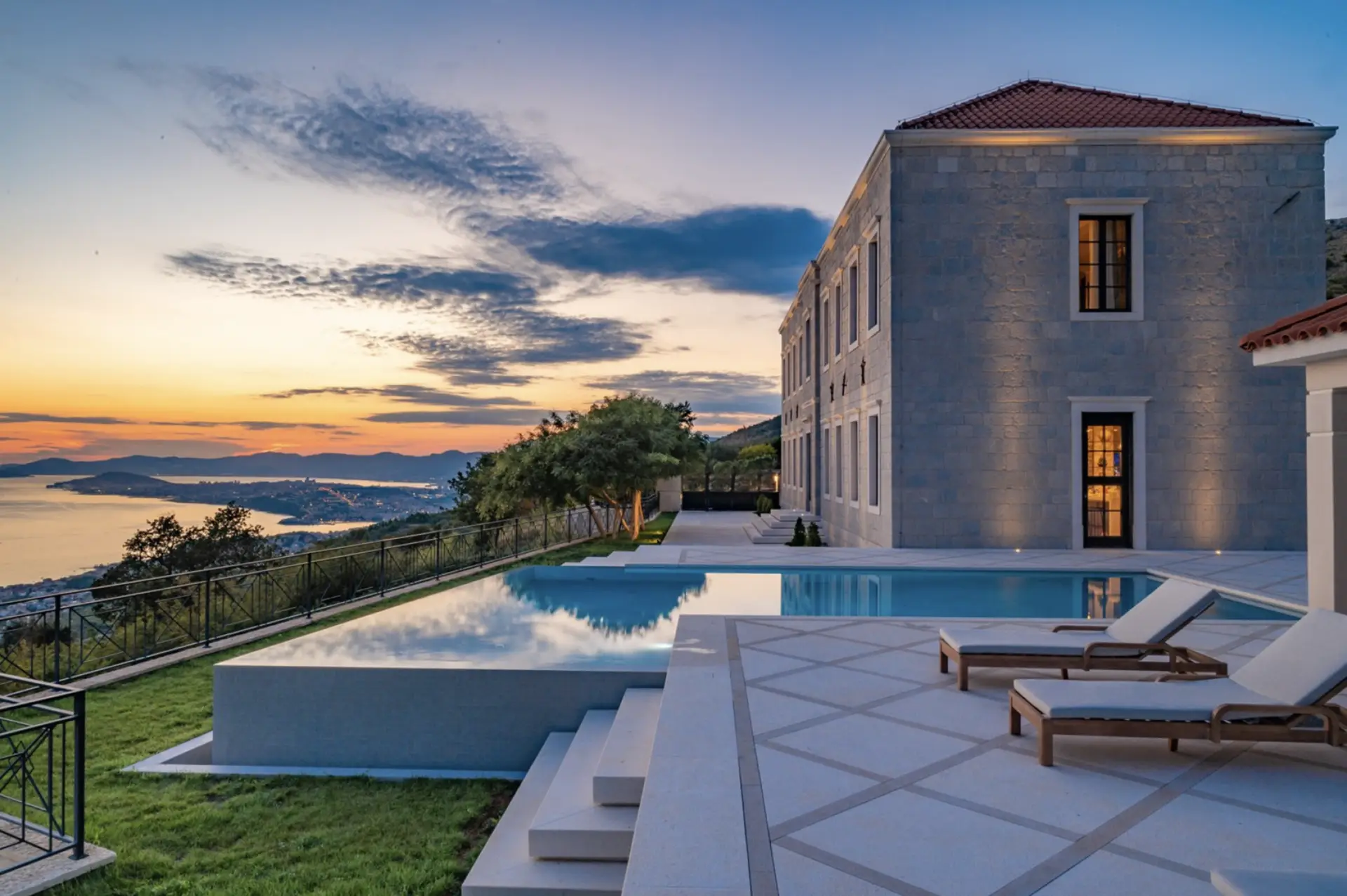 villa with a pool at sunset