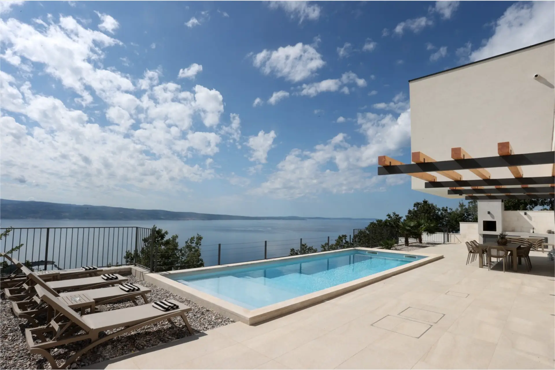 poll with sun lounges at the villa