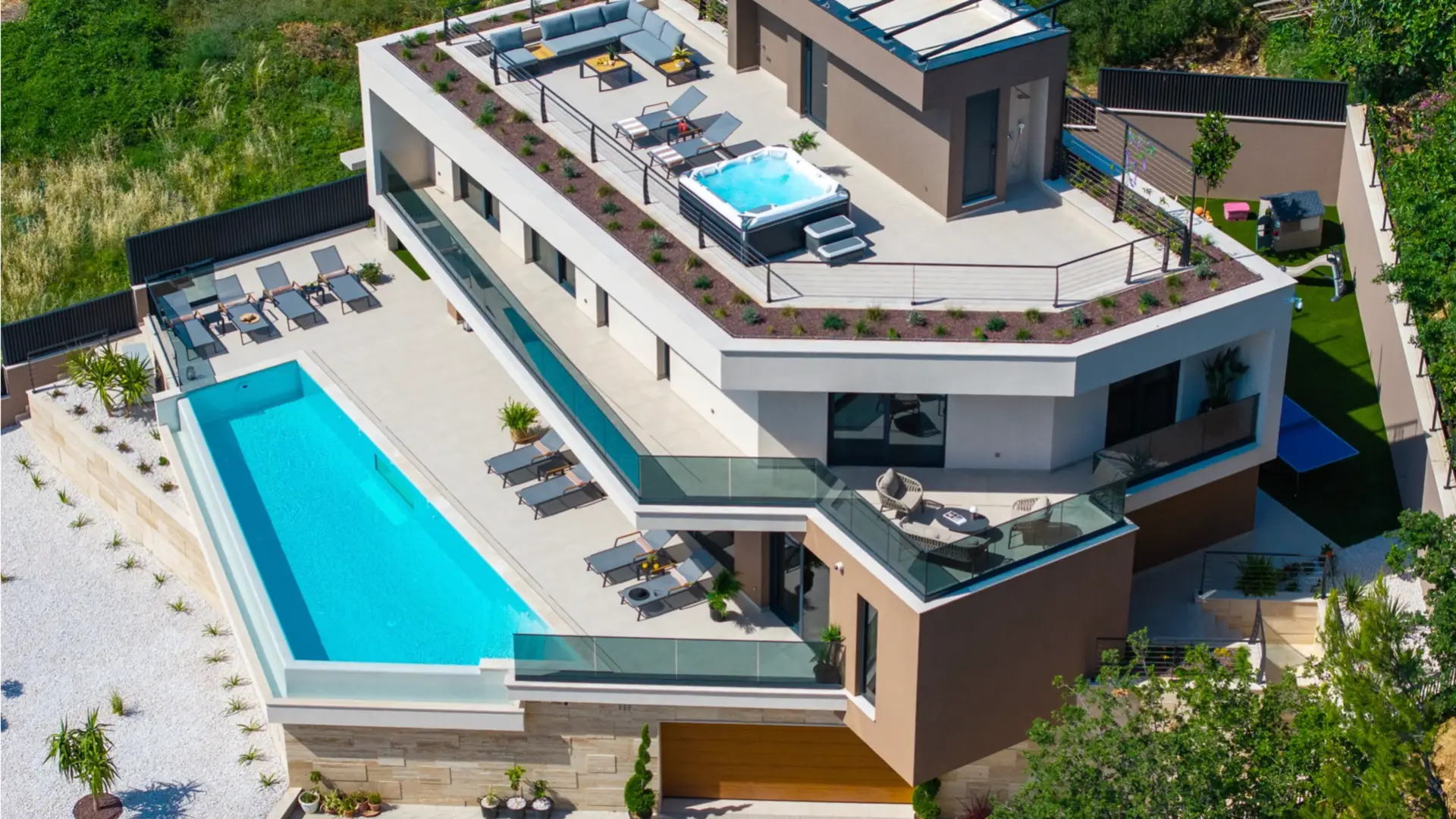 aerial view of a villa with a pool