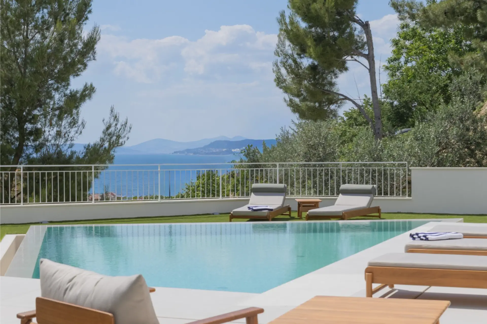 outdor pool are with sun loungers and sea view