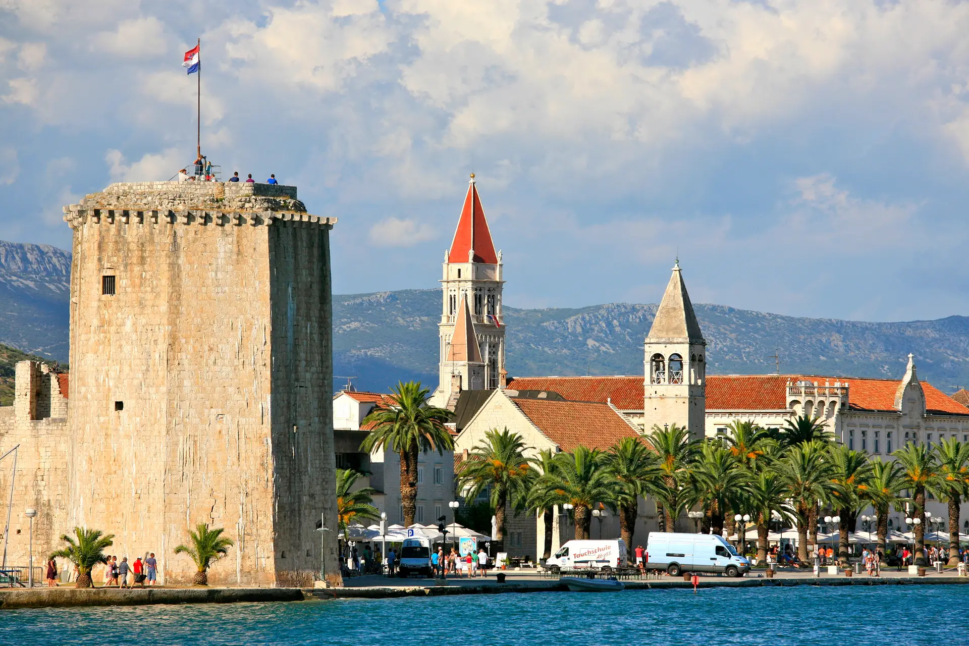 panoramic view of  historic town with palm trees at waterfront