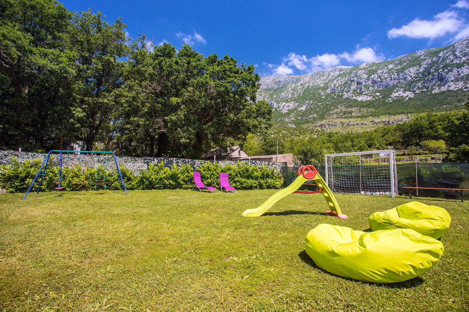 Kid's playground with swing and slide and football field