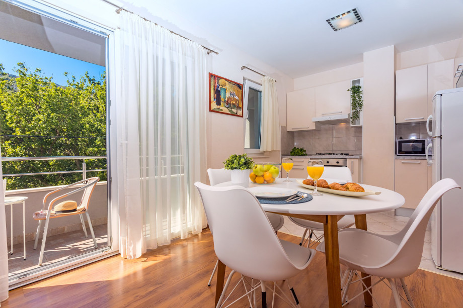 Kitchen and living area in AP1 with balcony