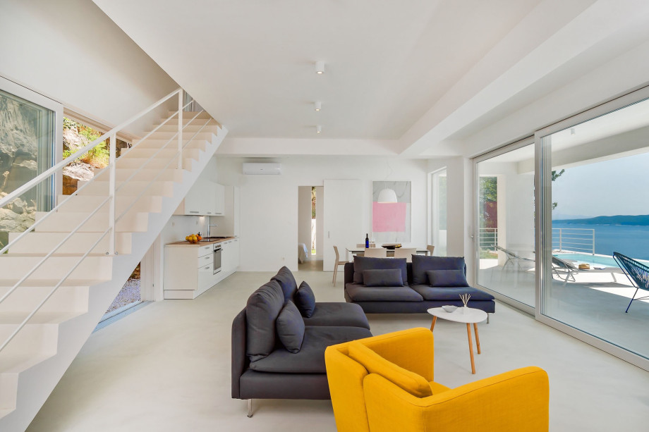 .Modern living area and stairs for upper floor with two bedrooms