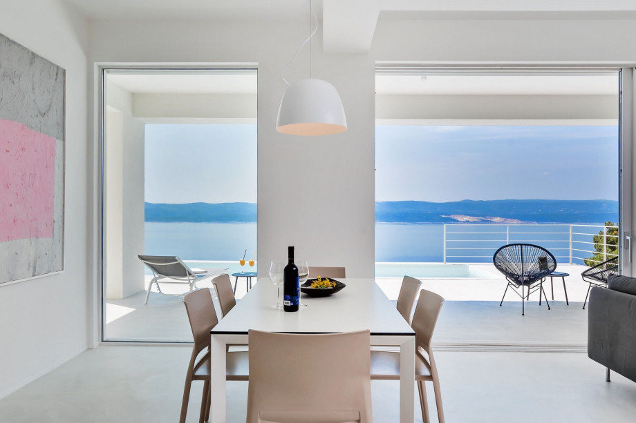 Dining area with opened sea views and exit to pool area