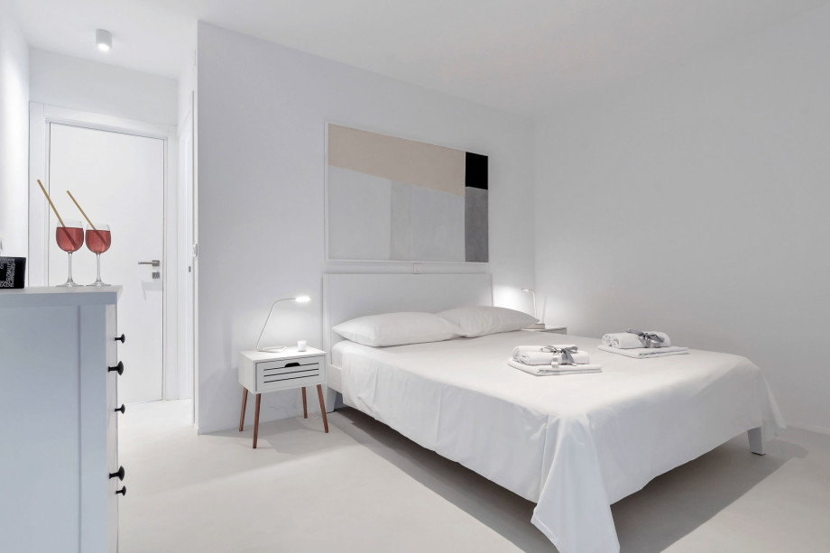 Bedroom on the 2nd floor with a double bed, bathroom, and exit to balcony