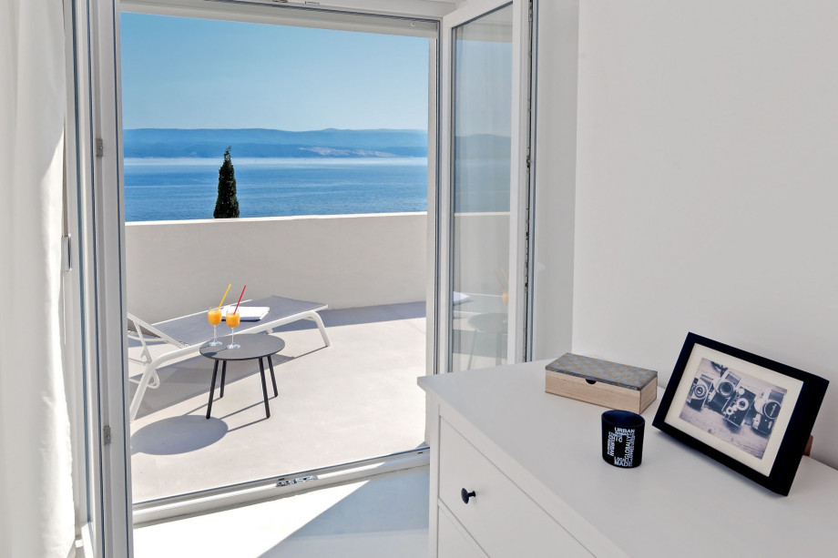 Sea view from bedroom and exit on big balcony with outdoor furniture