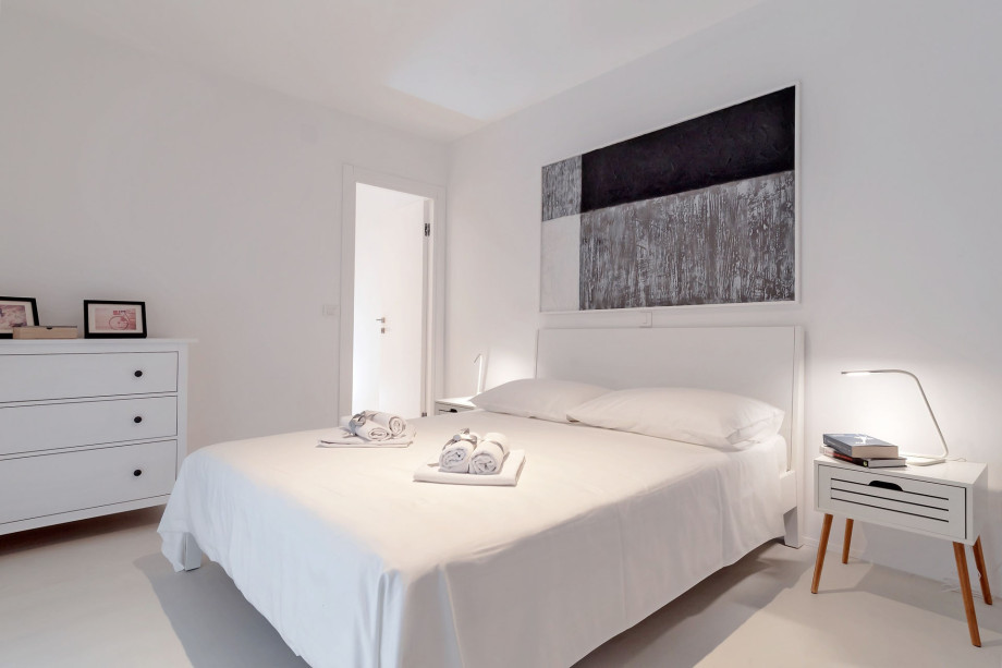 Bedroom on the 2nd floor with a double bed, bathroom, and exit to balcony