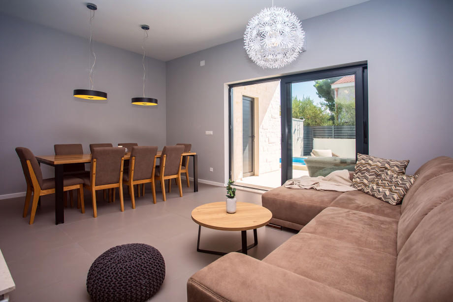 modern open living- and dinning room with exit to the pool area