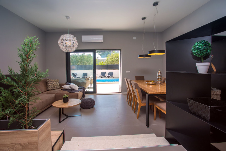 modern open living- and dining room with exit to the pool area