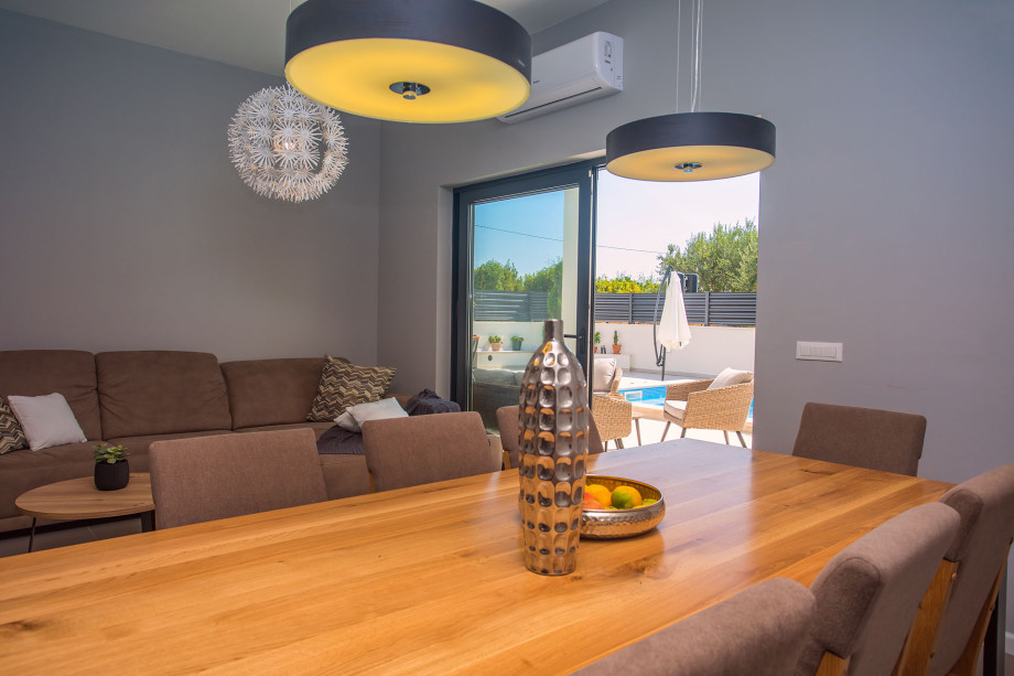 modern open living- and dining room with exit to the pool area