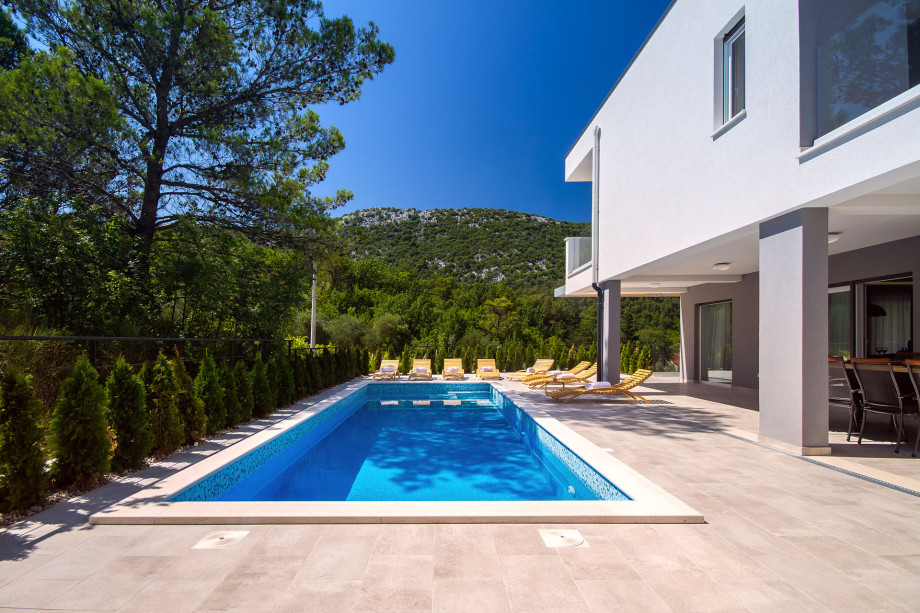 Heated 33sqm pool with attached 5sqm whirlpool and 8 comfortable lounge chairs