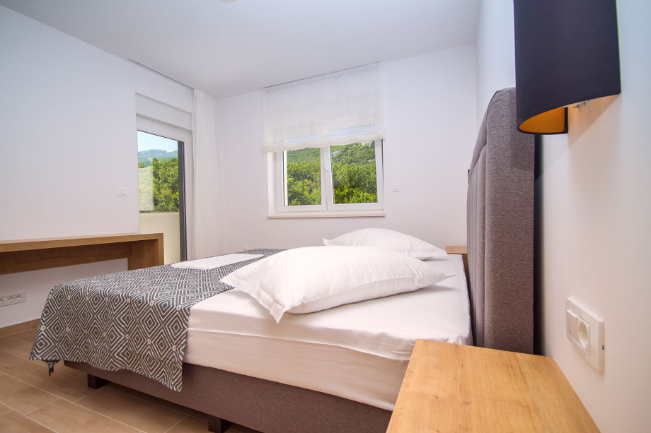 Bedroom No.2 with double bed, en-suite bathroom, exit to the balcony