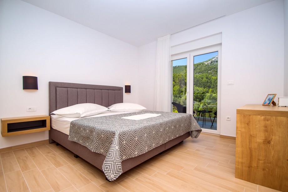 Bedroom No.3 with double bed, en-suite bathroom, exit to the balcony