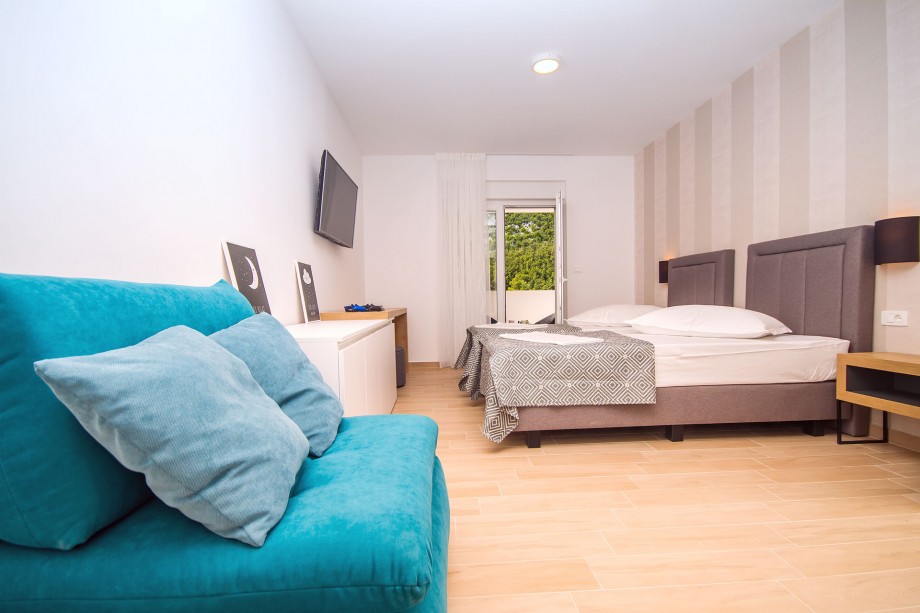 Bedroom No.4 with double bed and sofa bed,en-suite bathroom, exit to the balcony