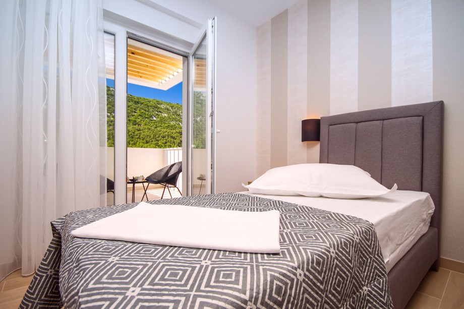 Bedroom No.4 with double bed and sofa bed,en-suite bathroom, exit to the balcony