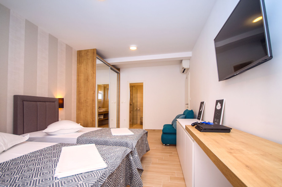 Bedroom No.4 with double bed and sofa bed,en-suite bathroom, exit to the balcony