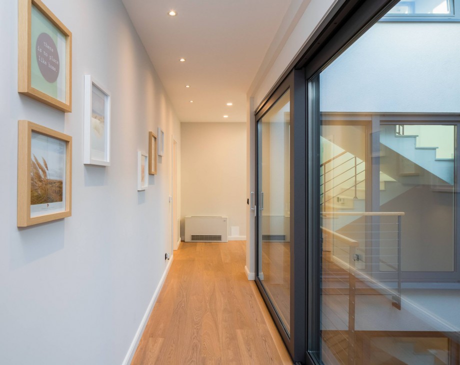 Hallway with glasswalls and garden views