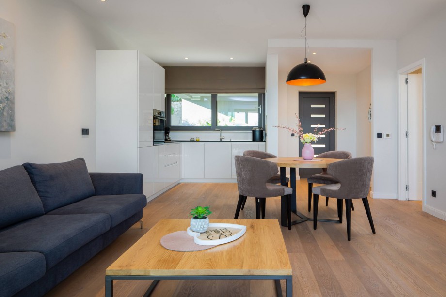 Living and dining area with a fully equipped kitchen on the ground floor next to outdoor dining area