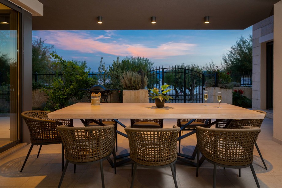 Enjoy evenings at the outdoor dining area with sandy beach views