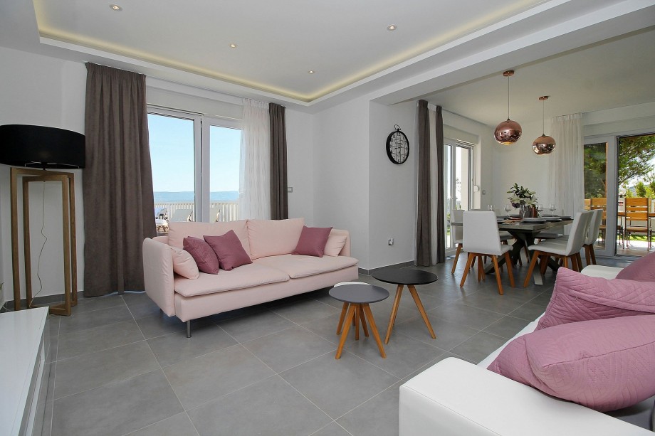 Living and dining area with sea and island view