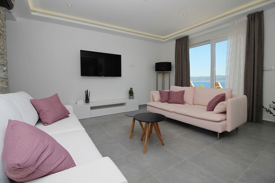 Living area with TV and direct exit to the pool