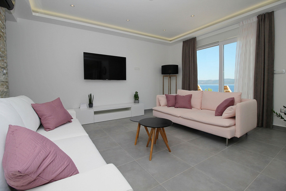 Living area with TV and direct exit to the pool