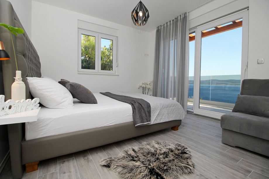 Bedroom on 1st floor with double bed and sofa bed, exit to the balcony