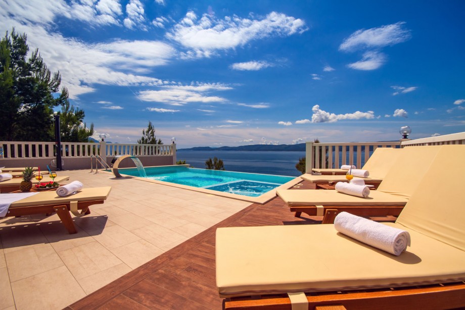 Pool area with 8 comfortable sun loungers, open sea view