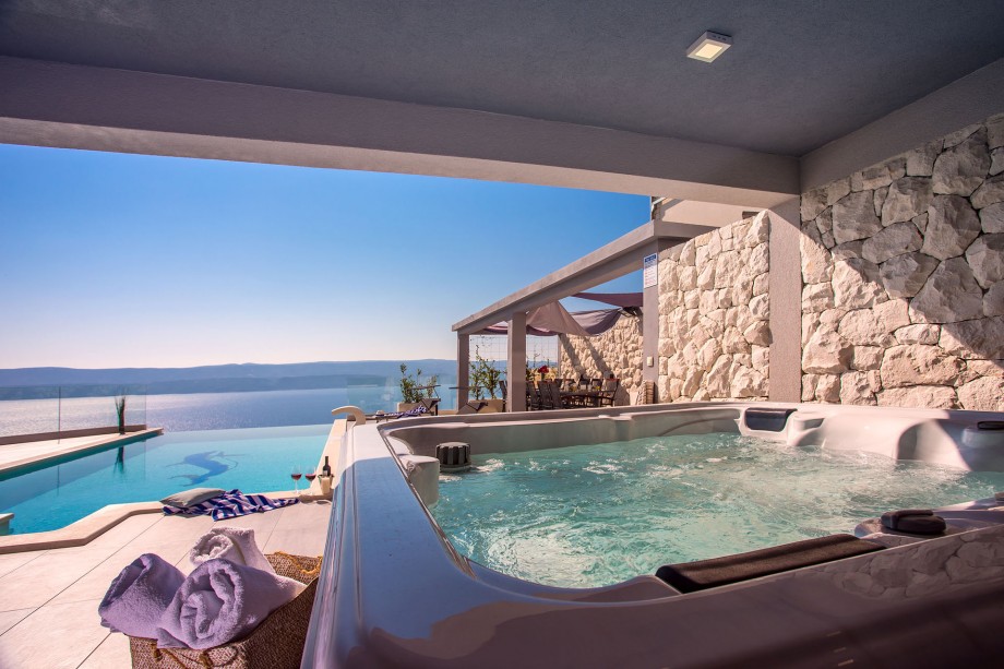 Sea view from the jacuzzi, private pool, sun deck area and outdoor furniture