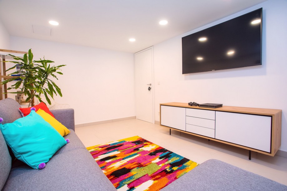 Playroom on the lower ground floor with a TV, a sofa and a Play Station 4