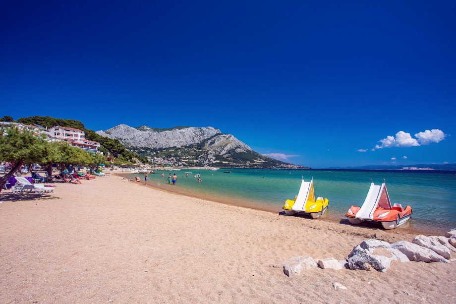 Sandy beach in front of the property with coffee bars, restaurants, water sports