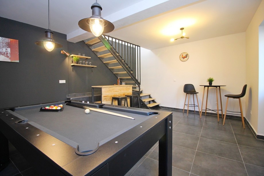 Game room with pool table and counter, great for relaxing