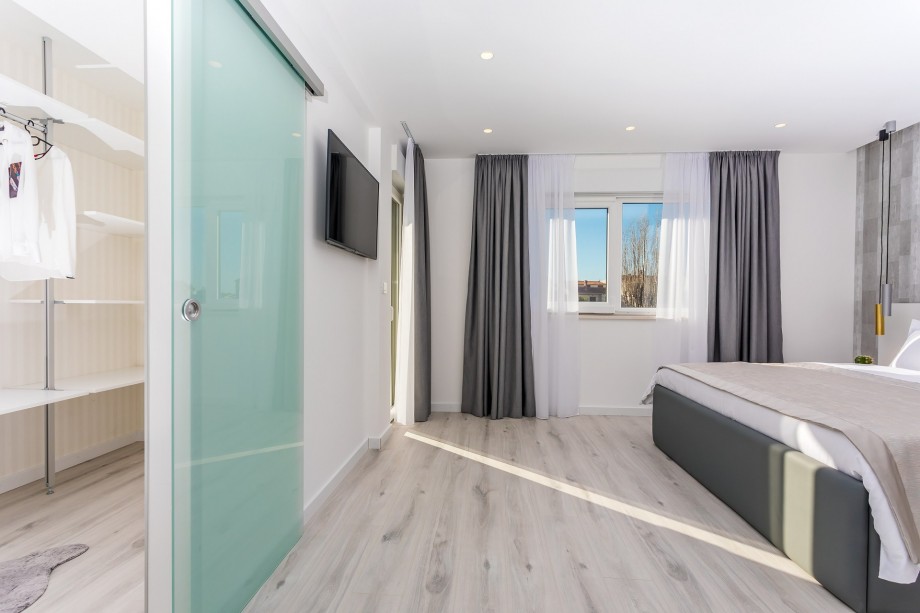 Master Bedroom No.2 with a king-size bed and walk-in closet