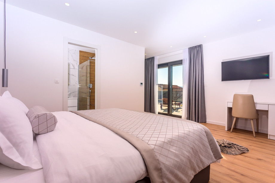 A Bedroom No.5 has access to a balcony with outdoor furniture