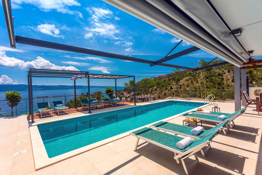 heated 11m x 3,6m private pool, huge sun deck area with 9 modern deck chairs