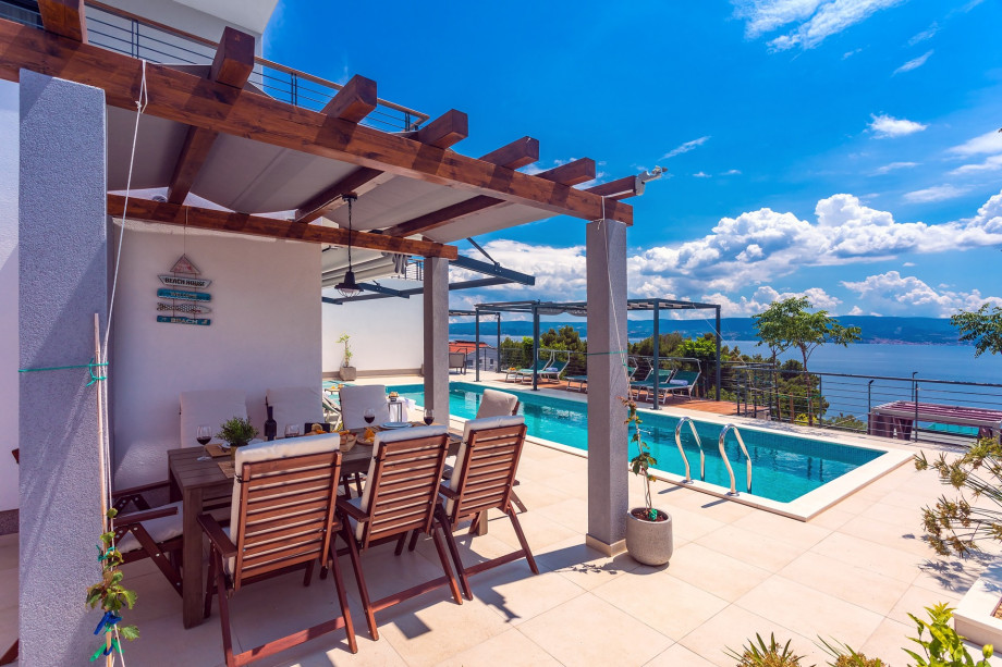 Dining area with barbecue and open sea views