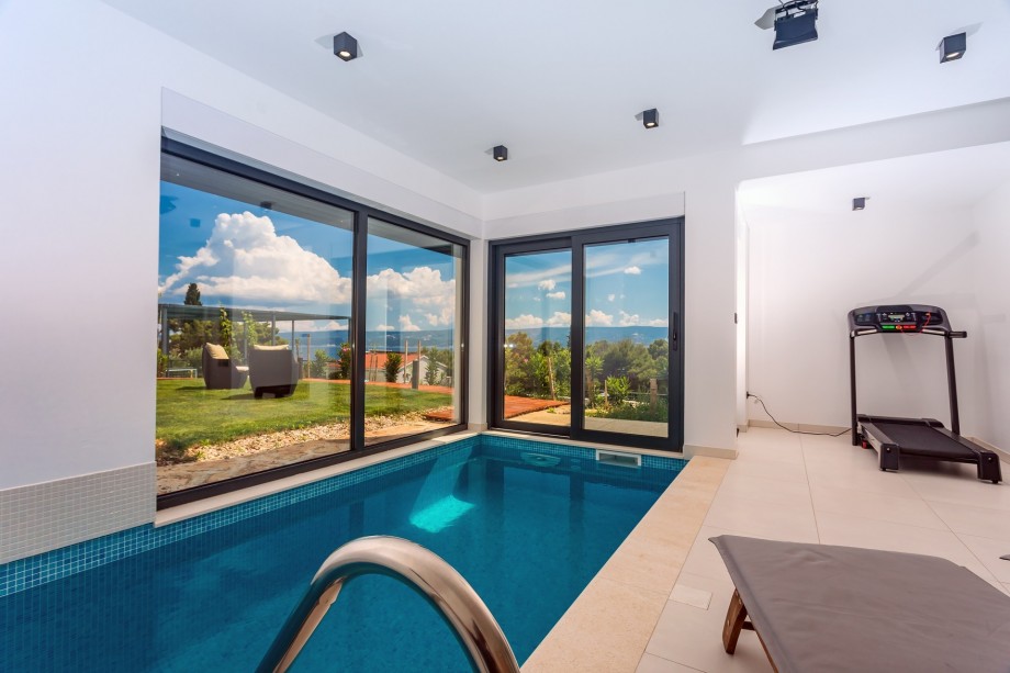 treadmill next to the indoor Pool & Sauna