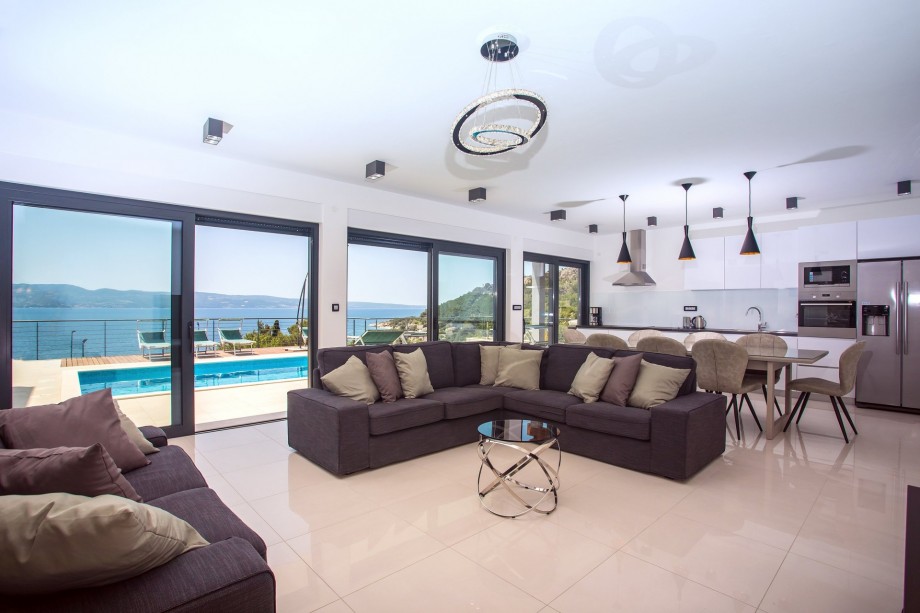 ground floor offers a spacious living room with floor-to-ceiling sliding glass