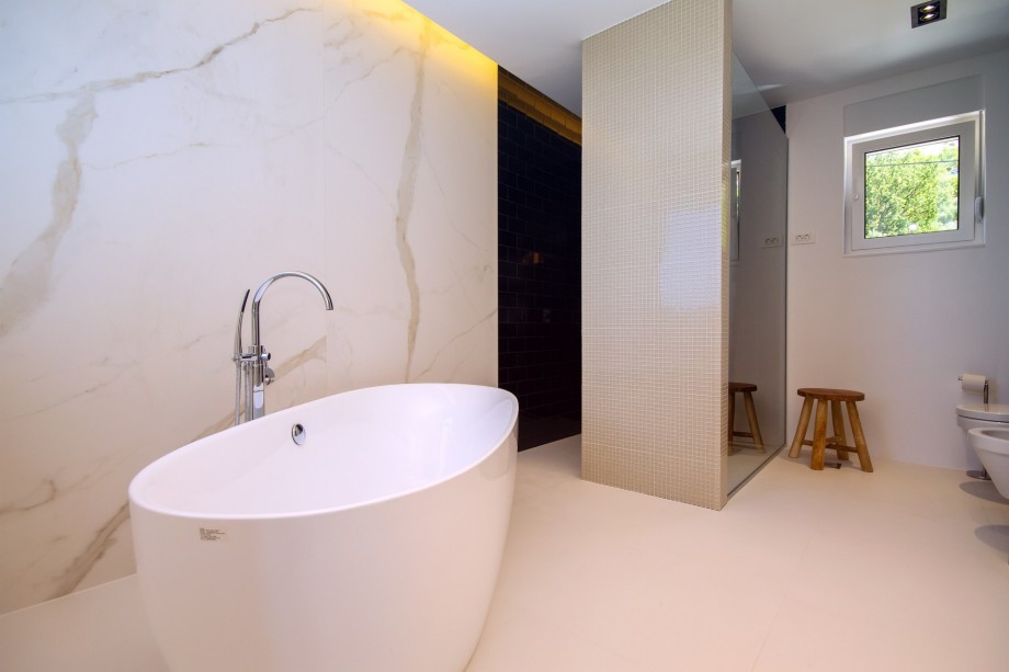 Bathroom in bedroom No.1 with double sink, bath and shower