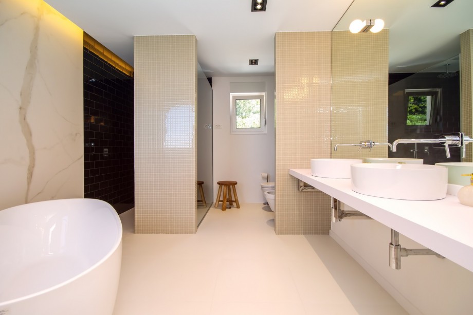 Bathroom in bedroom No.1 with double sink, bath and shower