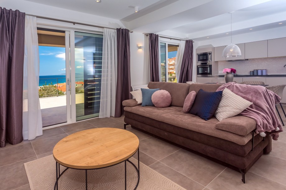 Spacious living area on the ground floor with TV, AC, and exit to the terrace.