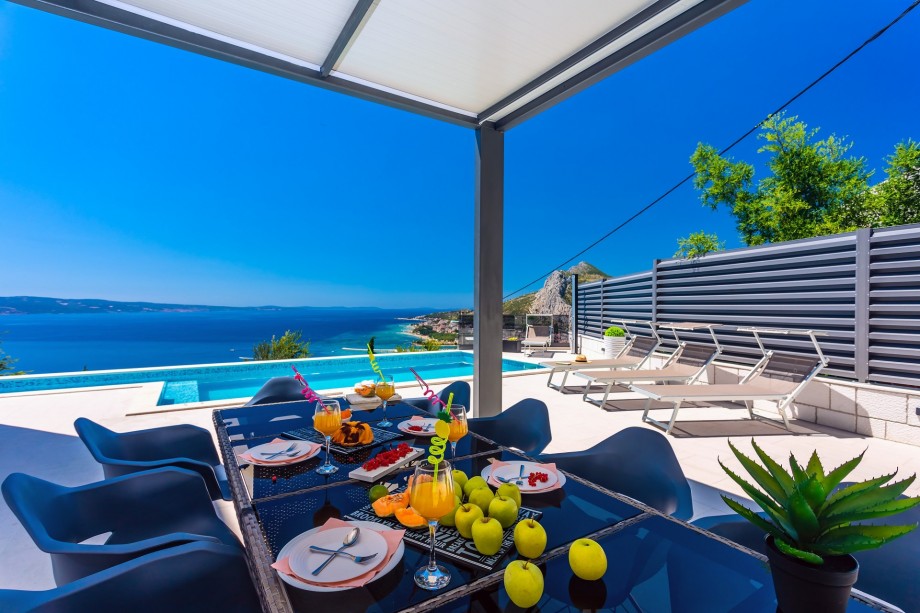 Spacious dining area in front of the summer kitchen.