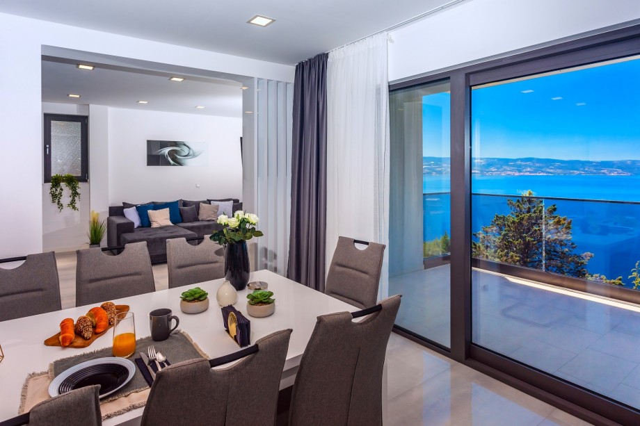 The dining area has an exit to a terrace with sea views