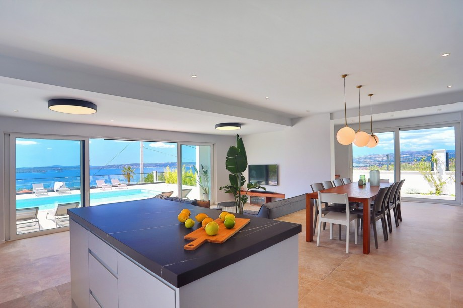 Tastefully furnished living area with exit to pool and outdoor dining area