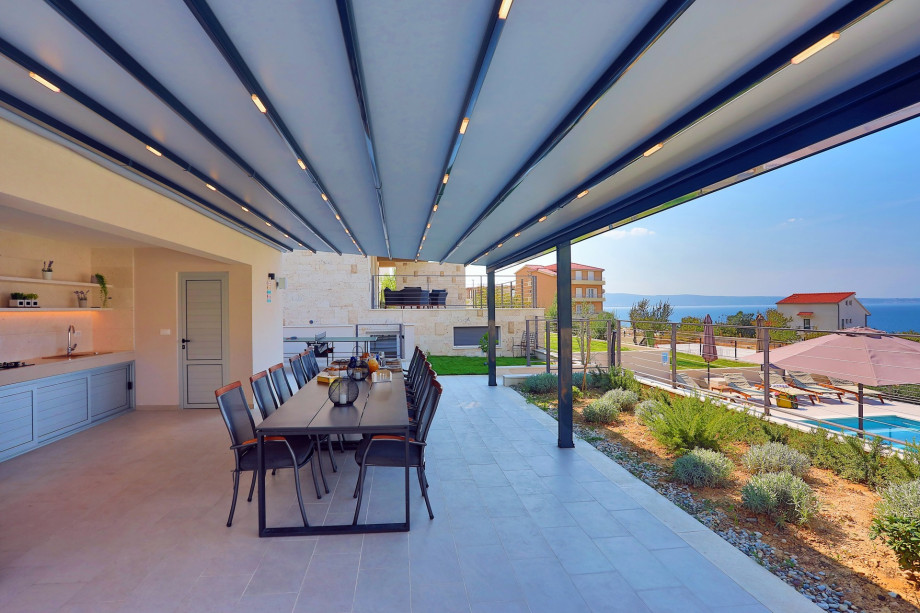 Spacious dining area in front of the summer kitchen.