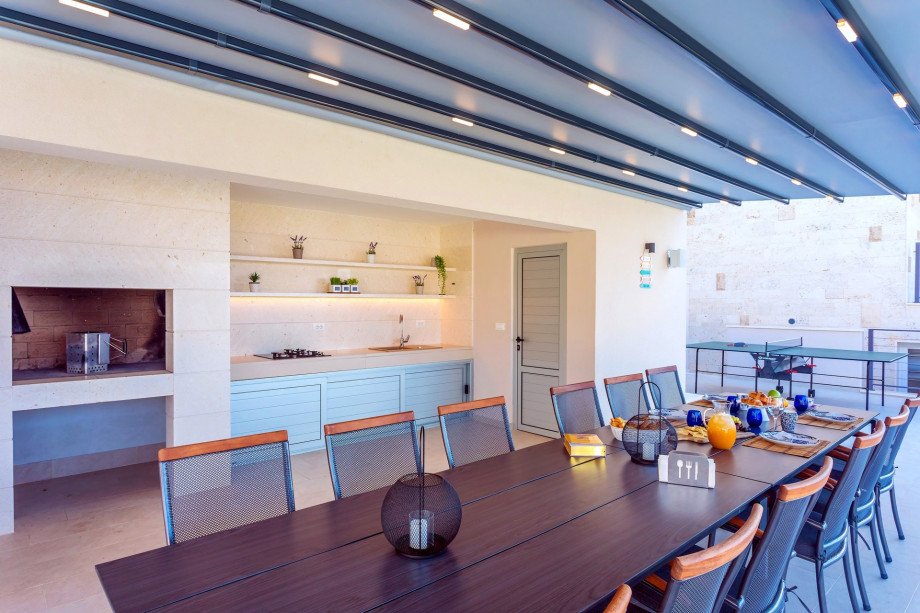 Fully equipped summer kitchen with barbecue and spacious dining area