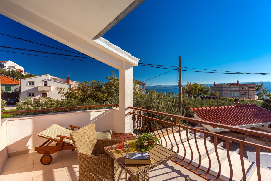 Bedroom No.5 with  balcony with a deck chair, sea and pool views