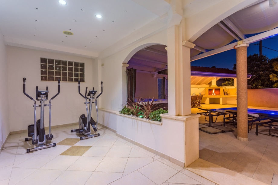 An outdoor Jacuzzi for 6 pax. 2 orbitrack fitness devices.